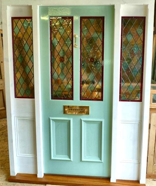 A Stained Glass Front Door With Frame And Sidelights